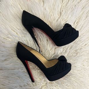 Christian Louboutin black knotted peep toe heel.
